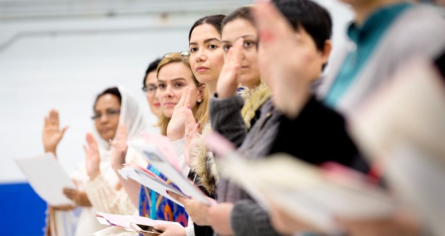 Immigrants take the Canadian oath of citizenship during a ceremony in Toronto. (Carlos Osorio/Toronto Star via Getty Images)