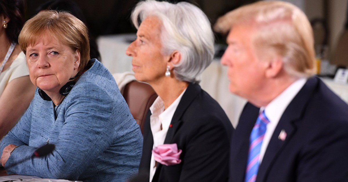 German Chancellor Angela Merkel looks past then-International Monetary Fund Managing Director Christine Lagarde toward U.S. President Donald Trump during a working breakfast at the G7 Summit in Quebec City, Canada, on June 9, 2018. (Leon Neal/Getty Images)