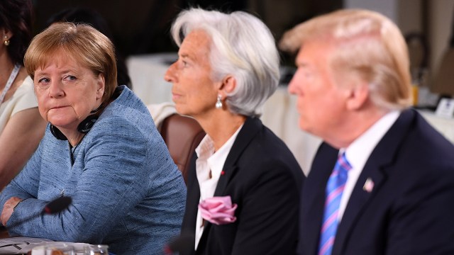 German Chancellor Angela Merkel looks past then-International Monetary Fund Managing Director Christine Lagarde toward U.S. President Donald Trump during a working breakfast at the G7 Summit in Quebec City, Canada, on June 9, 2018. (Leon Neal/Getty Images)
