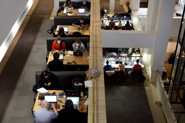 People work on their laptops at the British Library in London. (Kate Green/Anadolu Agency/Getty Images)
