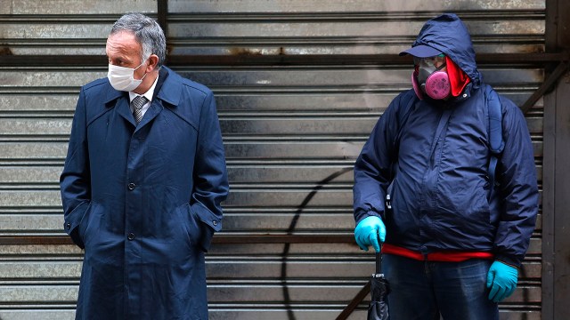 Jobless men wait to collect state bonds or loans aimed at middle-class Chileans amid a widespread coronavirus lockdown in July 2020 in Santiago. (Marcelo Hernandez/Getty Images)