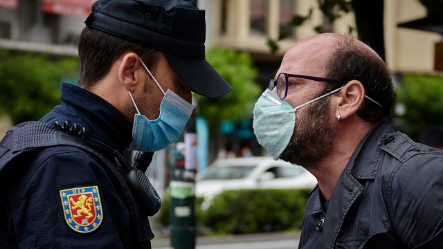 A pedestrian argues with a police officer in Pamplona, Spain, in May 2020. (Iranzu Larrasoana Oneca/NurPhoto via Getty Images)