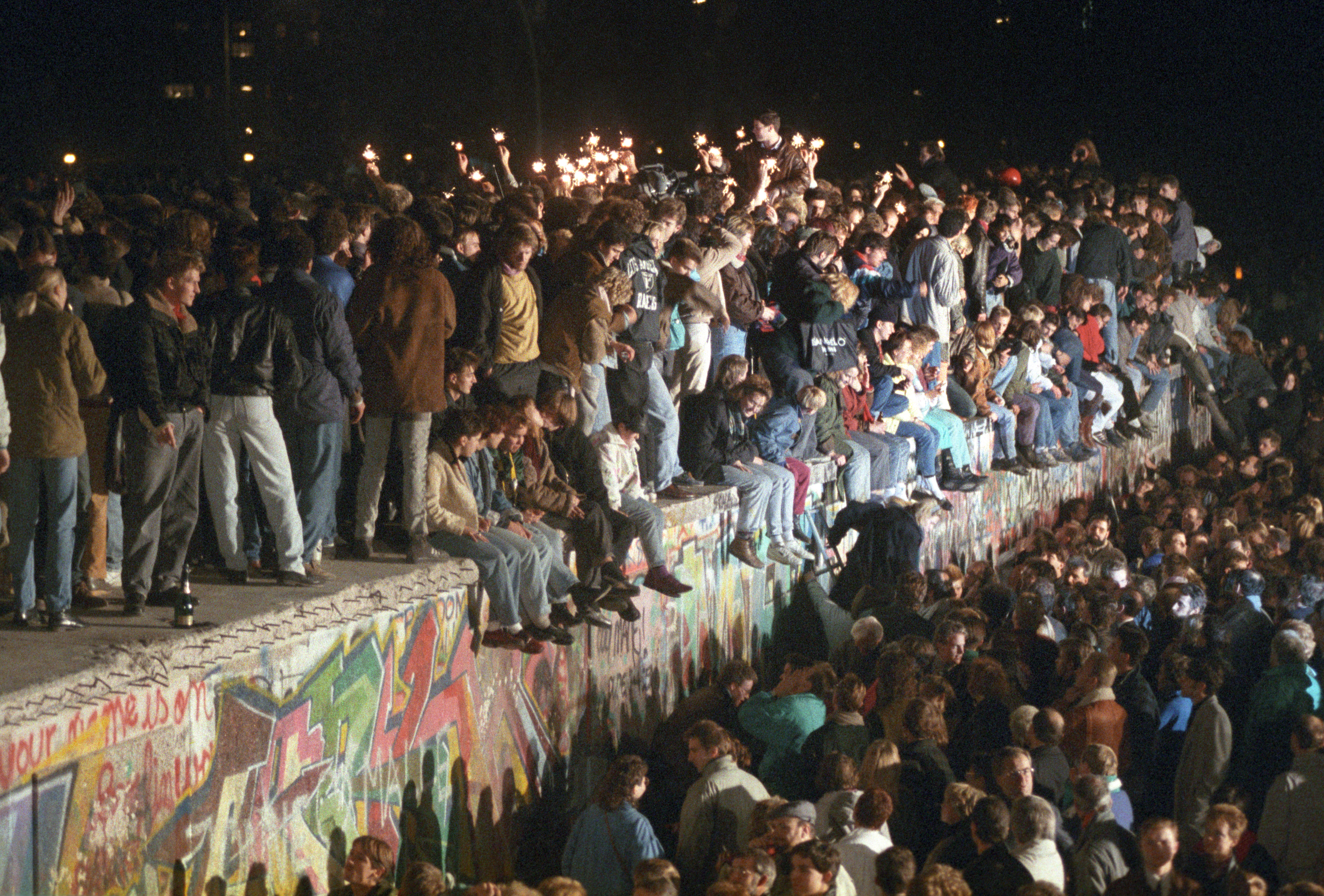 Berliners and people from all over Germany celebrate on the Berlin Wall on Nov. 11, 1989.