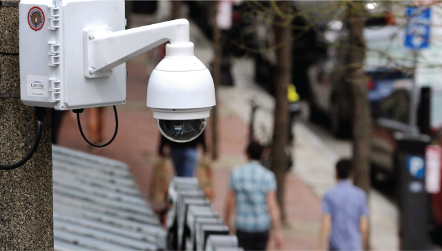 Photograph showing a surveillance camera above a Boston street in 2014.
