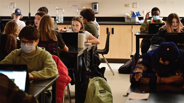 Photo showing students attend biology class in person at South High School in Denver in March 2022.