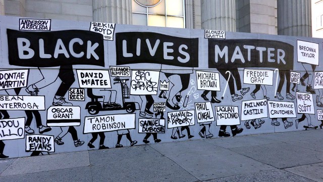 An image of A Black Lives Matter street sign in New York City depicting the names of Black victims of police violence.