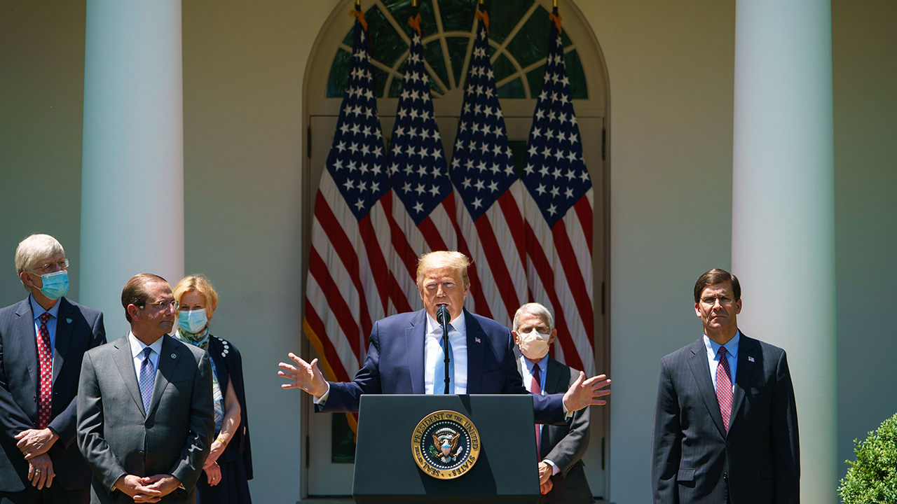 President Trump speaks on vaccine development in the White House Rose Garden on May 15, accompanied by NIH Director Francis Collins, HHS Secretary Alex Azar, coronavirus task force coordinator Deborah Birx, National Institute of Allergy and Infectious Diseases Director Anthony Fauci and Defense Secretary Mark Esper. (Mandel Ngan/AFP via Getty Images)
