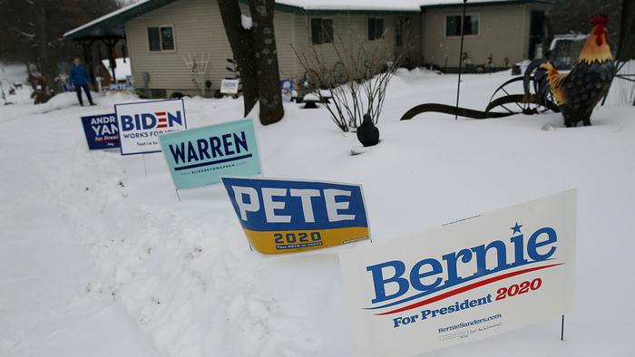 Campaign signs are visible in a front yard in Waverly, Iowa, on Jan. 25, 2020. (Boston Globe via Getty Images)