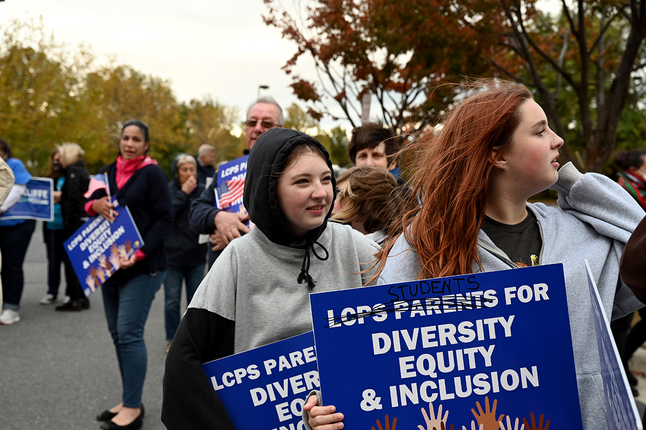Students, parents and others hold signs outside the Loudoun County school board meeting October 26, 2021 in Ashburn, VA. Loudoun County schools have been roiled with controversy and this is the first meeting after two in-school sexual assaults by the same student. (Photo by Katherine Frey/The Washington Post via Getty Images)