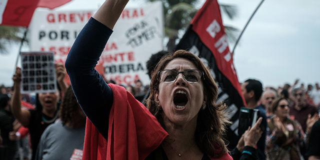 A protester shouts slogans in front of the home of Brazil's Lower House Speaker Rodrigo Maia during a protest against President Michel Temer in Rio de Janeiro on May 21, 2017. (Yasuyoshi Chiba/AFP/Getty Images)