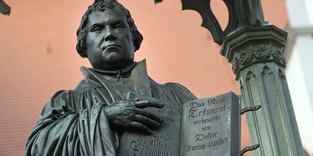 A statue of Martin Luther in Market Square in Wittenberg, Germany. In 1517 Luther nailed his 95 theses to a door of nearby Schlosskirche church, helping to spark the Protestant Reformation. (Sean Gallup/Getty Images)
