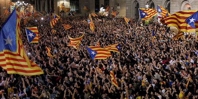 People gather at Placa Sant Jaume in Barcelona, Spain, to celebrate after Catalonia's parliament declares an independent Catalan republic on Oct. 27. (Pau Barrena/AFP/Getty Images)