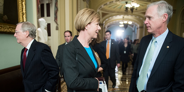 Democratic Sen.-elect Tammy Baldwin and Republican Sen. Ron Johnson, both of Wisconsin, talk in November 2012 at the Capitol as Minority Leader Mitch McConnell walks by. (Bill Clark/CQ Roll Call)