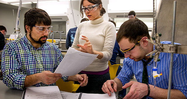 Teaching assistant Camille Lombard talks with students Bijan Ameli, left, and Mike Feigenbaum in a chemistry class at George Washington University in Washington, D.C., in 2015. (Linda Davidson/The Washington Post via Getty Images)
