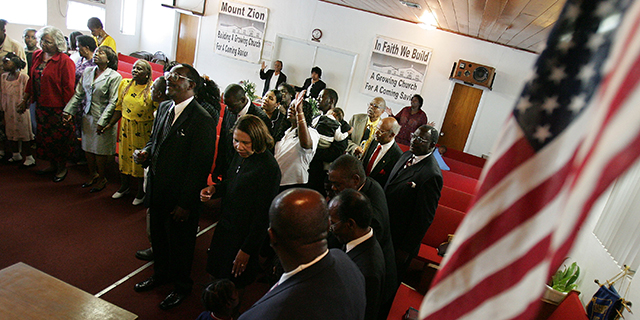 Worshipers pray during services at a church in the historically black Protestant tradition in Florida in 2004. More than half of black Americans are classified as members of this tradition. (Mario Tama/Getty Images)