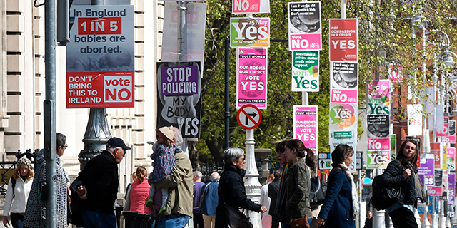 A Dublin street filled with signs for both sides ahead of Ireland's May 25 referendum on abortion. The country overwhelmingly voted to overturn the constitutional amendment banning most abortions. (Artur Widak/AFP/Getty Images)