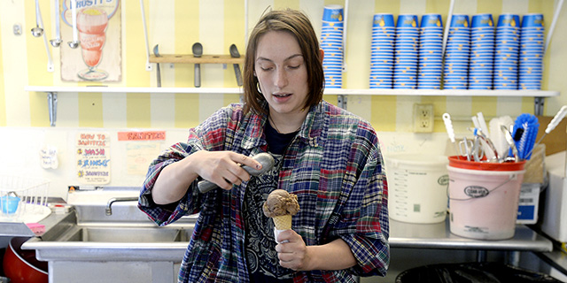 Morgan Jackson, 18, scoops ice cream while working at Beals Ice Cream in Portland, Maine, on April 26, 2018. (Shawn Patrick Ouellette/Portland Press Herald via Getty Images)