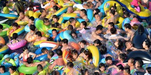 People at a water park in China, which is home to the world's largest population. Half of the world's population lives in just seven countries.
