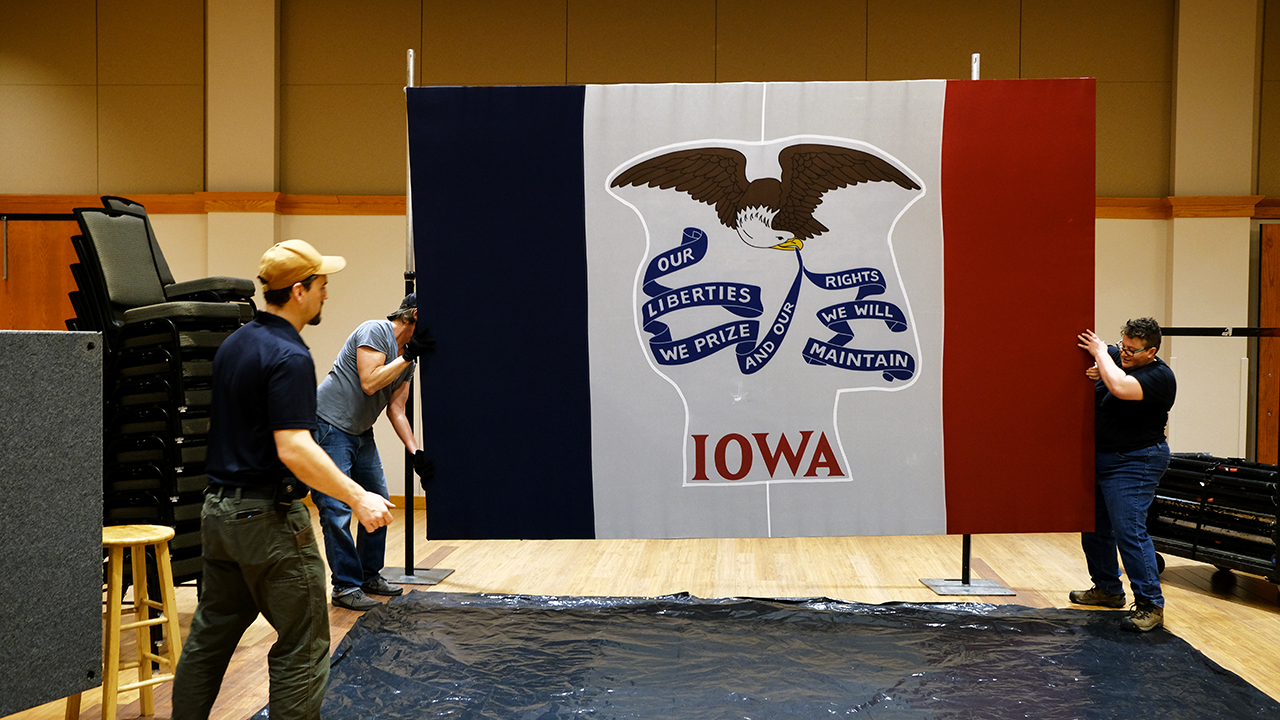 Workers take down the state flag on Jan. 15, 2020, in Cedar Falls, Iowa. (Spencer Platt/Getty Images)