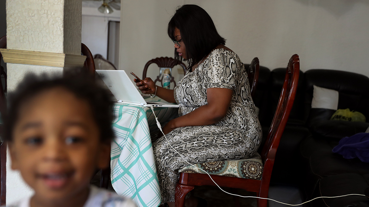 A woman in Hollywood, Florida, fills out an unemployment application online after being laid off from her job at the nearby airport. (Joe Raedle/Getty Images)