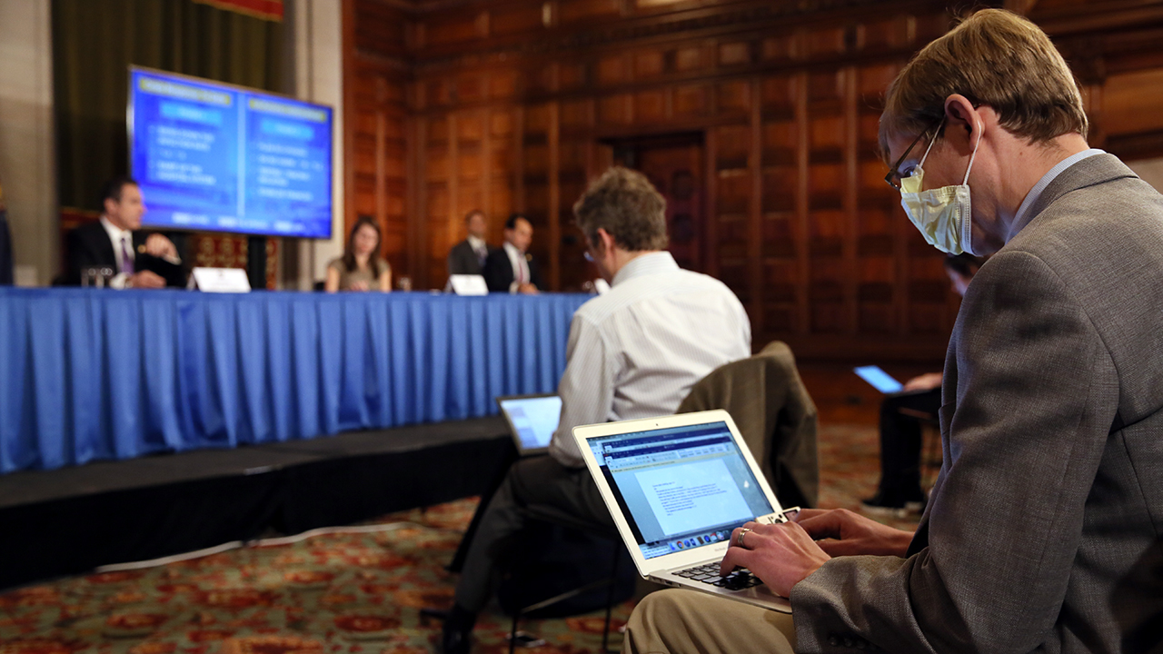 A reporter wearing a mask attends New York Governor Andrew Cuomo's press briefing about the coronavirus on April 17, 2020, in Albany, New York. (Matthew Cavanaugh/Getty Images)