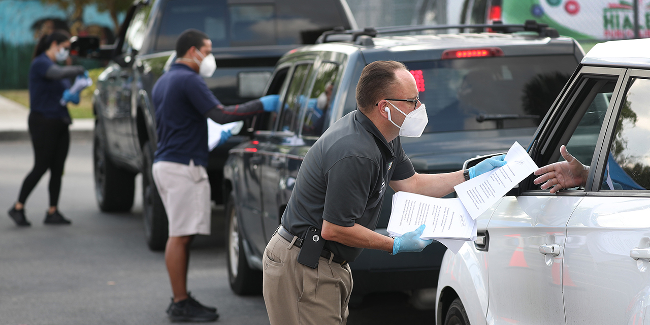 City of Hialeah employees hand out unemployment applications on April 8, 2020, in Hialeah, Florida. (Joe Raedle/Getty Images)