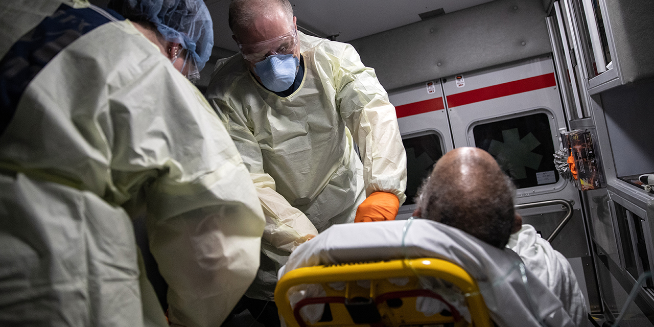 Medics take a black patient showing COVID-19 symptoms from his apartment to a hospital in Stamford, Connecticut, on April 4. (John Moore/Getty Images)