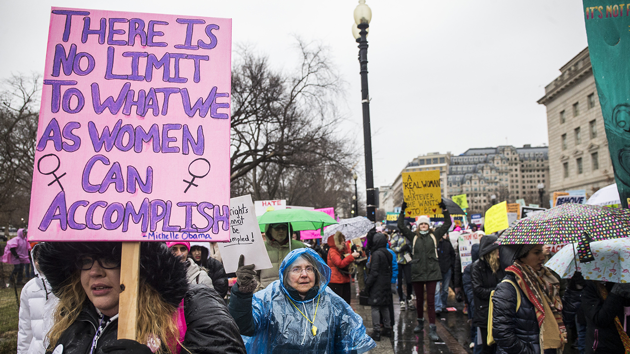 Demonstrators carry signs during the 2020 Women's March on Jan. 18 in Washington, D.C. (Zach Gibson/Getty Images)