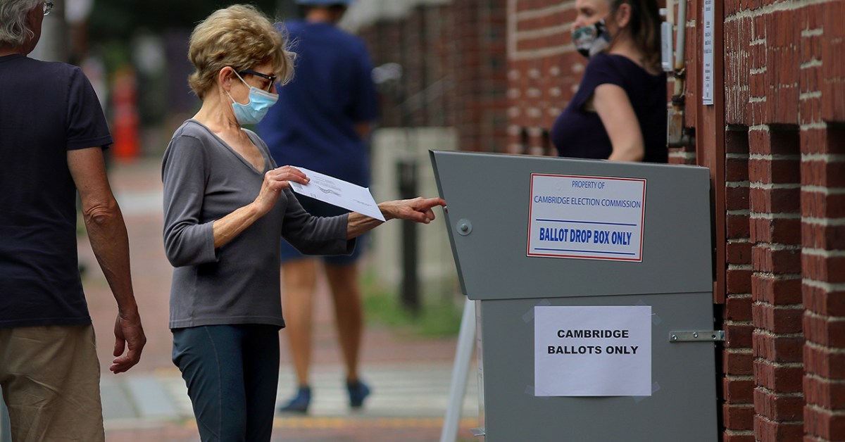 A voter drops off a mail-in ballot in a collection box in Cambridge, Massachusetts, on Aug. 25, 2020. ( Lane Turner/The Boston Globe via Getty Images)