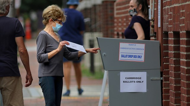 A voter drops off a mail-in ballot in a collection box in Cambridge, Massachusetts, on Aug. 25, 2020. ( Lane Turner/The Boston Globe via Getty Images)