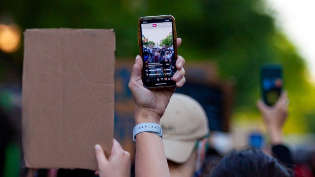 Demonstrators live-stream a protest in Chicago on June 1, 2020. (Javage Logan/Xinhua via Getty)