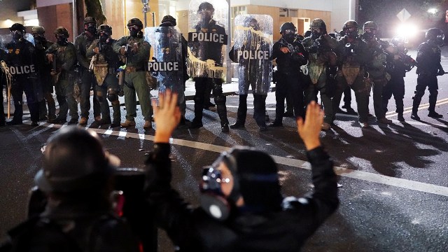 Federal officers and protesters face off in front of the Immigration and Customs Enforcement detention facility in Portland, Oregon, on Aug. 20, 2020. (Nathan Howard/Getty Images)