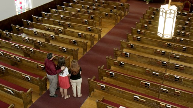 A family inside the Dexter Avenue King Memorial Baptist Church. (Jeffrey Greenberg/Universal Images Group via Getty Images)