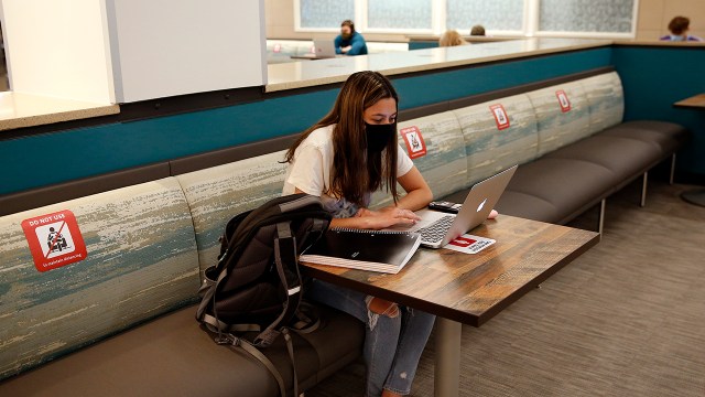 Sophomore Katherine Pacheco sits alone to do remote schoolwork at Boston University in Boston on Sept. 23, 2020. (Jessica Rinaldi/The Boston Globe via Getty Images)