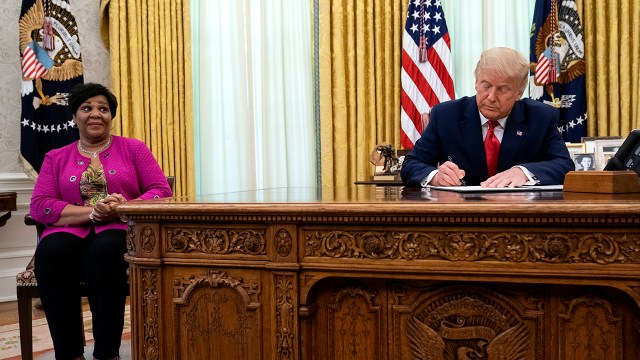 President Donald Trump signs a pardon for Alice Johnson, who was serving a life sentence on drug-related charges, on Aug. 28, 2020, in Washington. (Evan Vucci/AP)