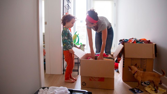 A young boy helps his mother unpack toys at their new home in El Cerrito, California, in September 2020. They had moved to be closer to family in part because of COVID-19. (Brittany Hosea-Small/AFP via Getty Images)