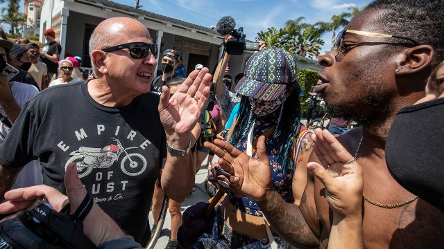 Two men argue as protesters demonstrate against a so-called White Lives Matter rally on April 11, 2021, in Huntington Beach, California.