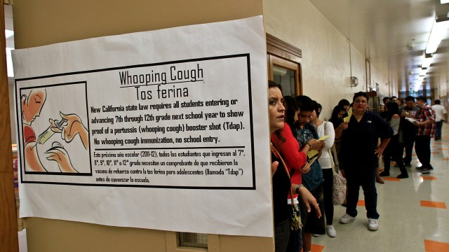 Students at Huntington Park High School in California wait in line to submit proof of immunization.