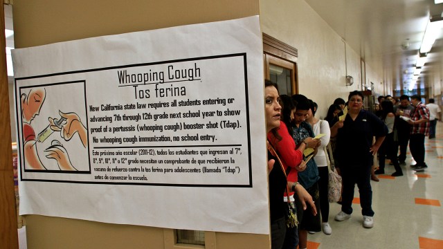 Students at Huntington Park High School in California line up to submit proof of vaccination.