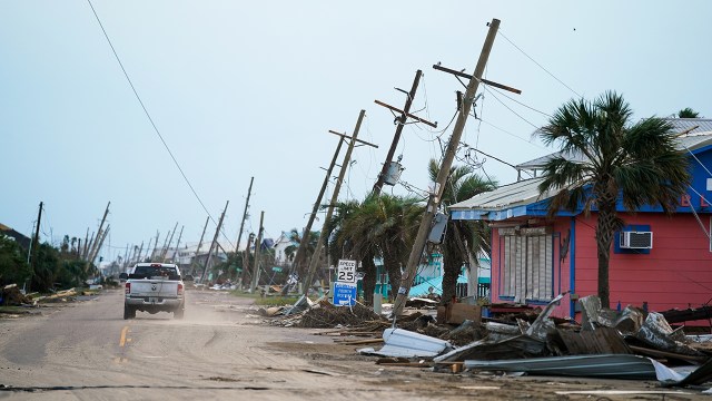 A motorist drives down a road in the wake of Hurricane Ida on Sept. 4, 2021, in Grand Isle, Louisiana. The Category 4 hurricane brought flooding, wind damage and power outages along the Gulf Coast.