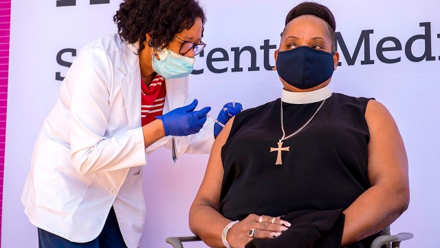 A pastor receives a COVID-19 vaccine at St. Vincent’s Medical Center on Feb. 26, 2021, in Bridgeport, Connecticut.