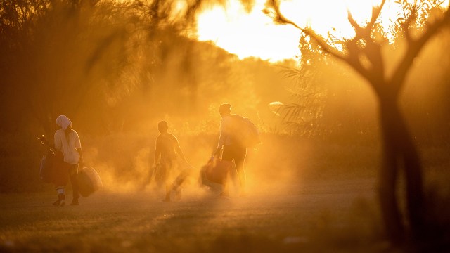 Immigrants walk toward the Rio Grande to cross into Del Rio, Texas, on Sept. 23, 2021, from Ciudad Acuna, Mexico.