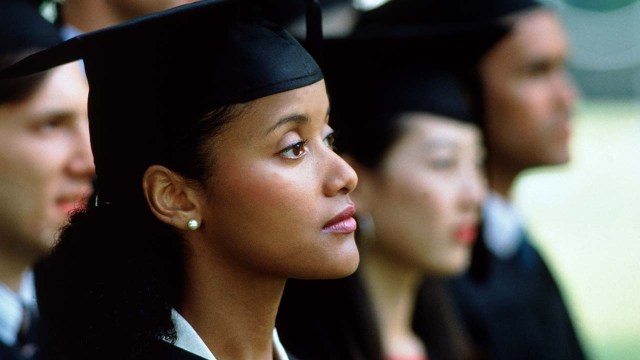 University graduates sit at a graduation ceremony.