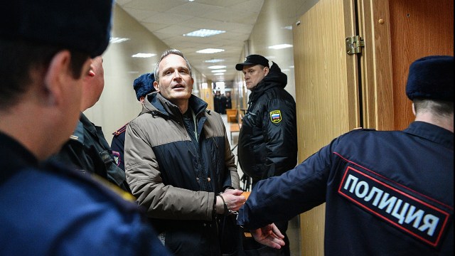 A Danish Jehovah's Witness accused of extremism is escorted into a courtroom to hear his verdict in the town of Oryol, Russia, on Feb. 6, 2019.