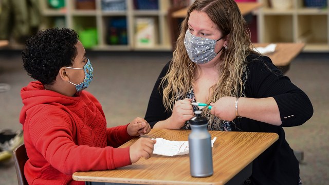 A teacher assists a fourth-grade student at Cumru Elementary School in Cumru Township, Pennsylvania, in 2021.
