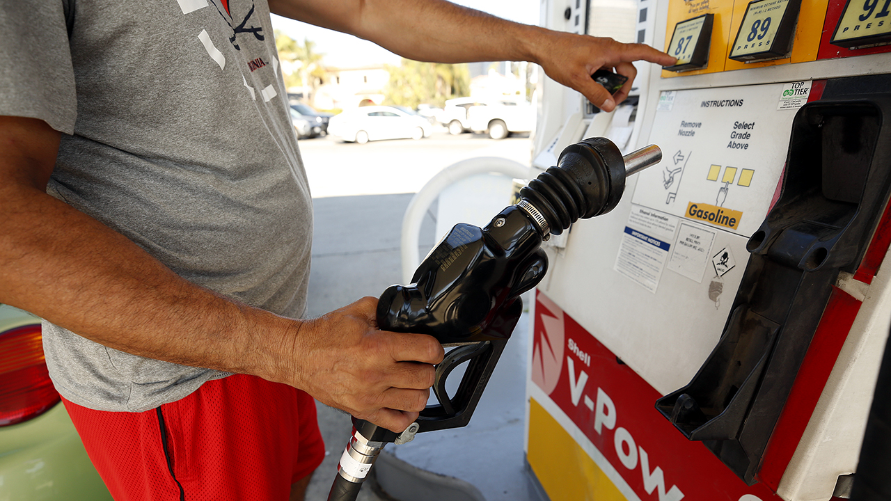 een chauffeur maakt zijn keuze uit verschillende brandstoffen geprijsd boven $6 bij een Shell tankstation in Los Angeles op Nov. 15, 2021.