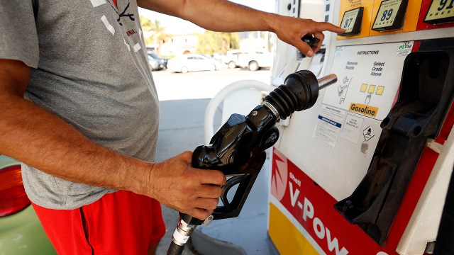 A driver makes his selection from various fuels priced over $6 at a Shell gas station in Los Angeles on Nov. 15, 2021.