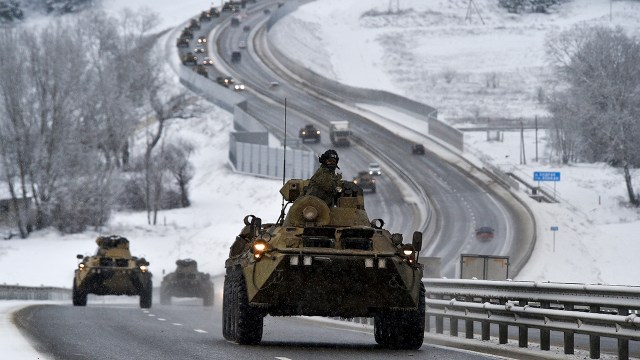 A convoy of Russian armored vehicles moves along a highway in Crimea on Jan. 18, 2022.