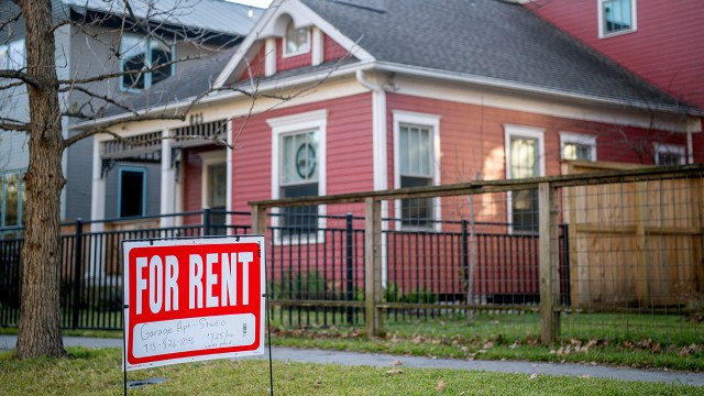 A “For Rent” sign is posted near a home in Houston in February 2022.