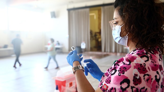 A nurse prepares a dose of the Pfizer COVID-19 vaccine at a clinic targeting minority community members at St. Patrick's Catholic Church in Los Angeles on April 9, 2021.